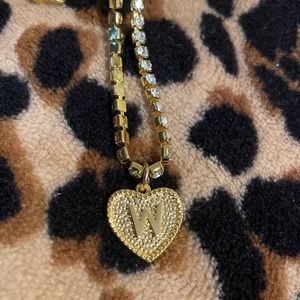 Gold necklace with diamonds, heart shaped, W engraved.